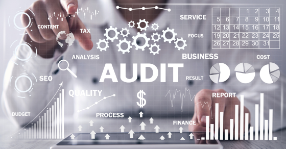 financial words such as audit, process, business, etc. floating in the foreground and a person dressed in white pointing at it in the background Your First Financial Audit: What Small Business Owners Need to Know cjg partners