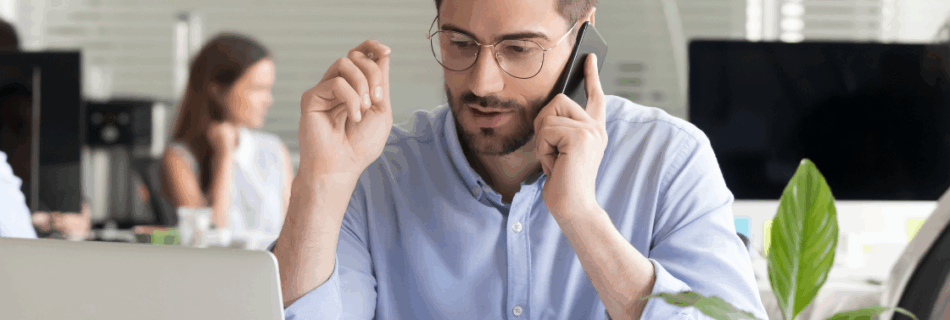 man with glasses and beard on the phone at a desk Is Your CPA Really Looking Out for You