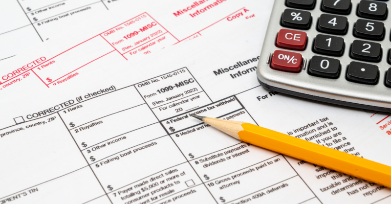 1099 misc form pencil and calculator Stop Scrambling: How to Prepare Your Business for Tax Season