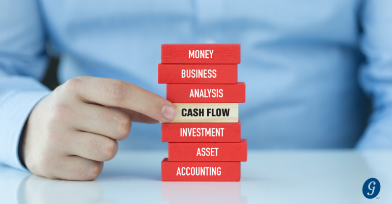 stack of blocks with words and a finger pointing to cash flow cjg partners accounting firm schaumburg