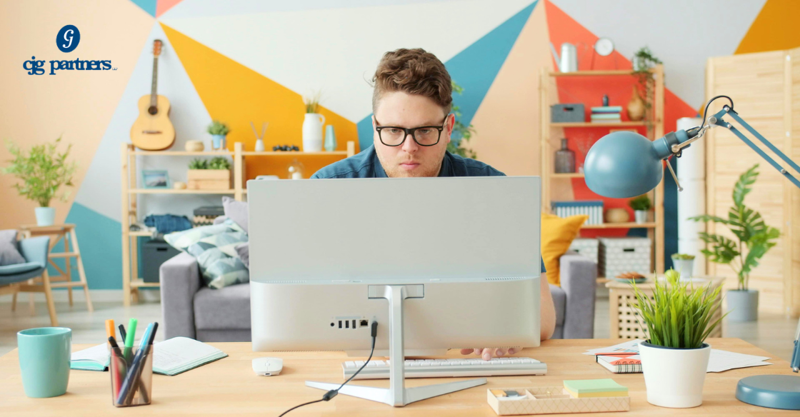 man working at a desk in a home office tax deductions cjg partners cpa accounting