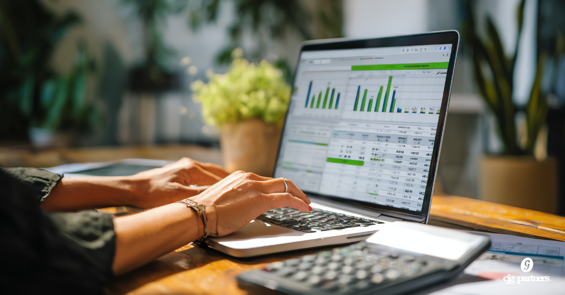 woman's hands typing on a laptop with bookkeeping software on the screen and a calculator in the foreground Bookkeeping Services for Schaumburg Small Businesses That Actually Make Sense bookkeeping services schaumburg
