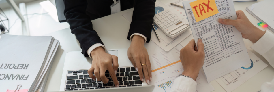 Two people working at a conference table on tax preparation Business Tax Preparation in Schaumburg: What to Expect From a CPA Who Actually Knows Your Business business tax preparation Schaumburg