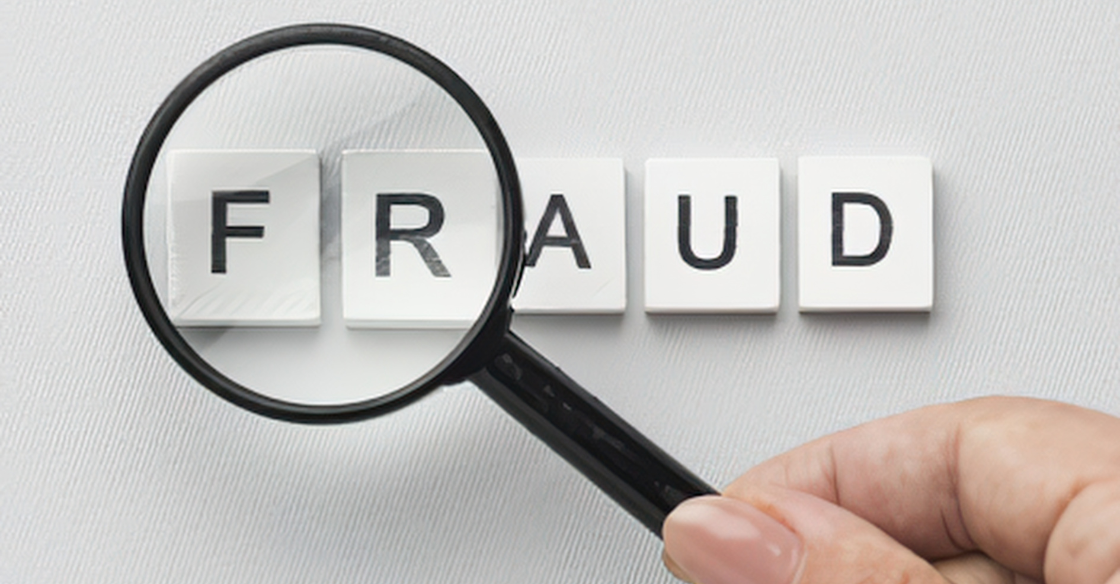 magnifying glass over the word fraud in scrabble tiles Fraud Risk Assessment: What Auditors Look for During Your Audit cjg partners