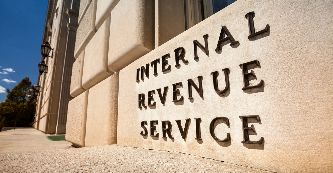 American flag with an envlope in the foreground that says IRS What to Do When You Get an IRS Notice cjg partners
