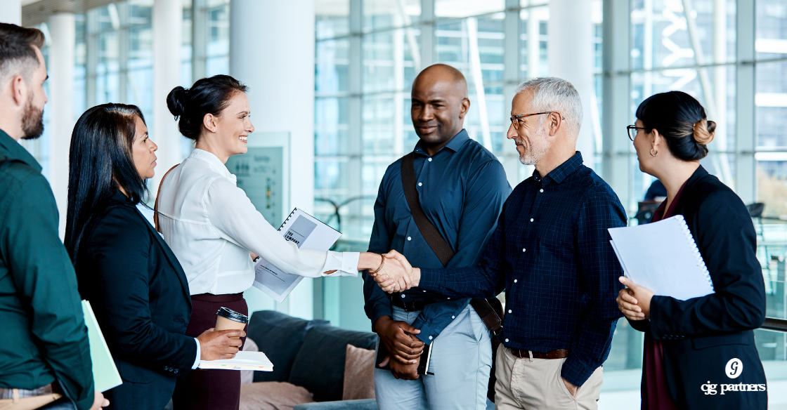 three people facing three other people and one person from each group is shaking hands and they are in an office setting What to Know Before You Buy or Sell a Business